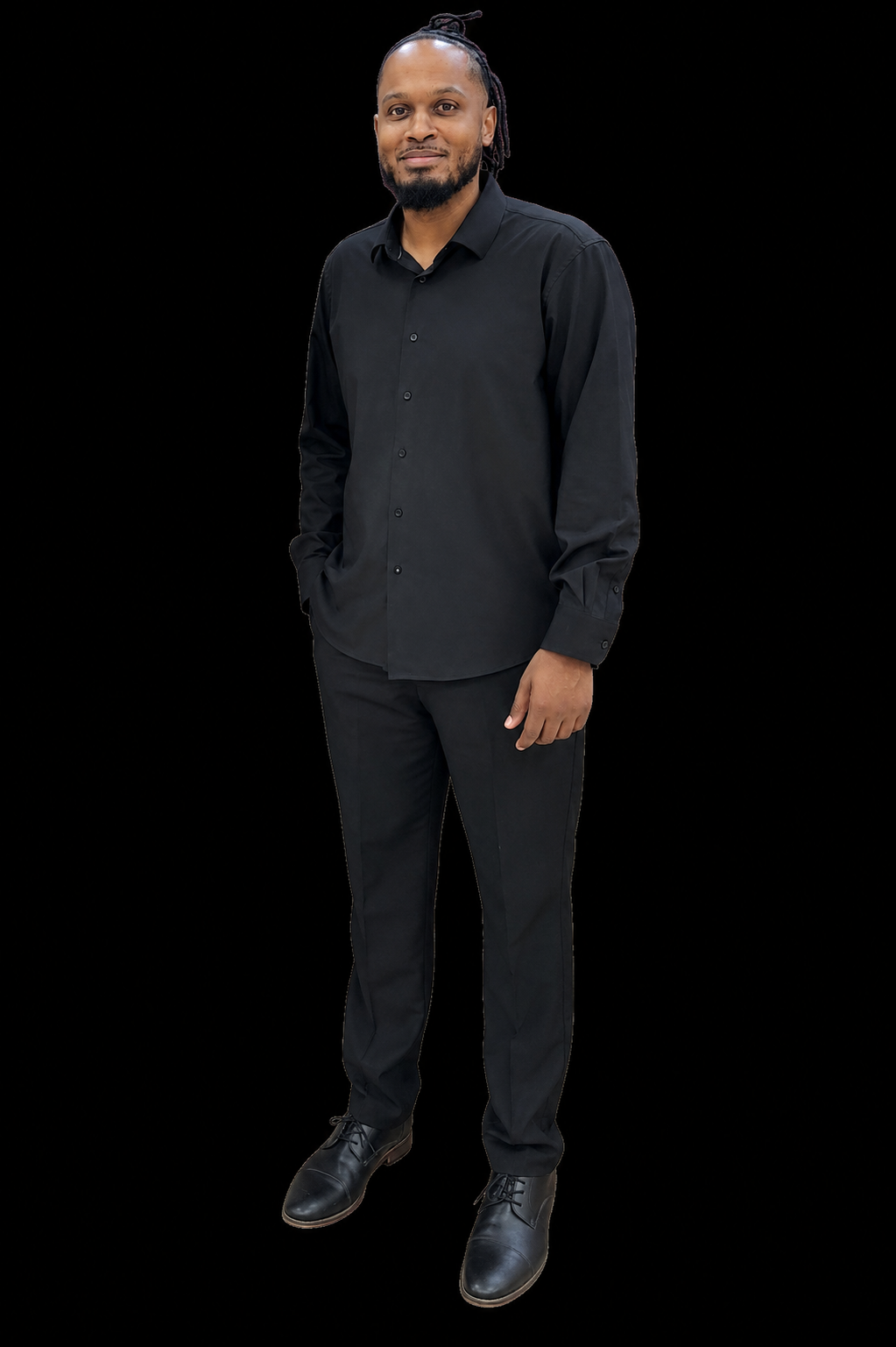William Randolph standing in a black button-down shirt and black trousers